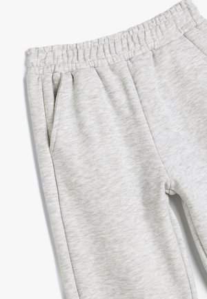 Pantaloni tuta grigi in felpa con vita elasticizzata, tasche laterali e un motivo texturizzato e melange.