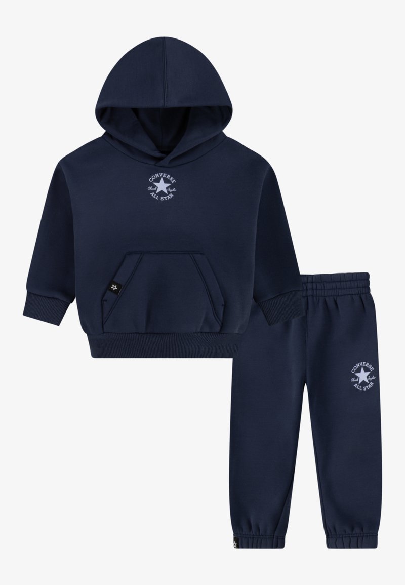Navy blue cotton hoodie with front pocket and embroidered logo, paired with matching jogger pants featuring elastic waistband and cuffs.