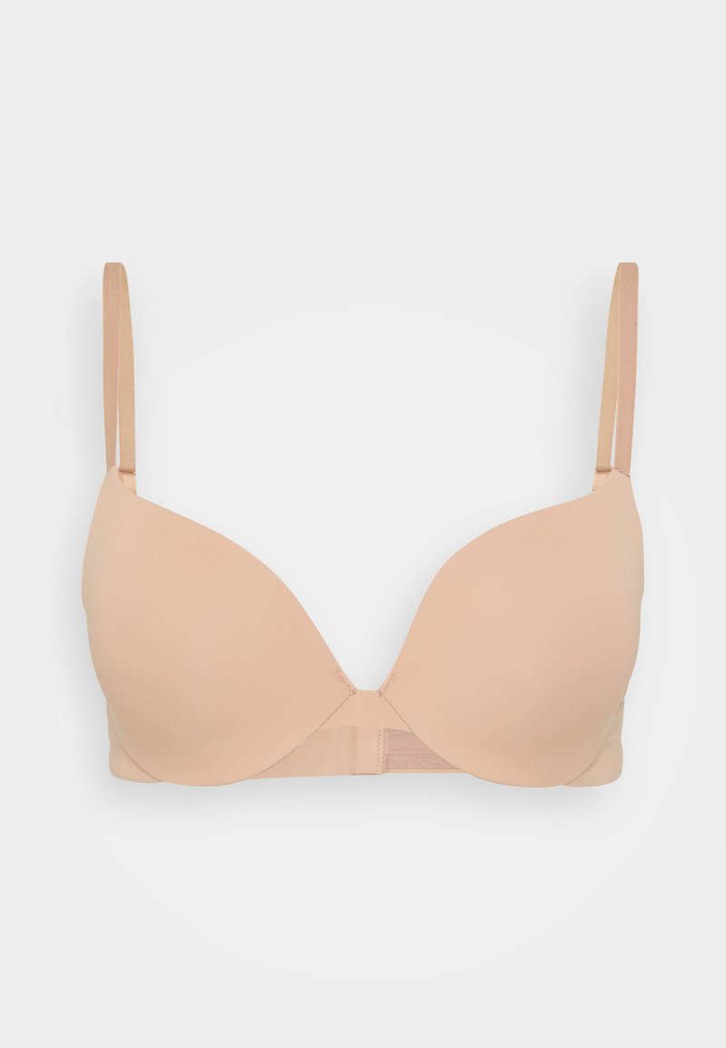 Nude bezprzewodowy biustonosz z gładkimi, wyprofilowanymi miseczkami, regulowanymi ramiączkami i miękkim materiałem; posiada zapięcie na haftkę z tyłu.