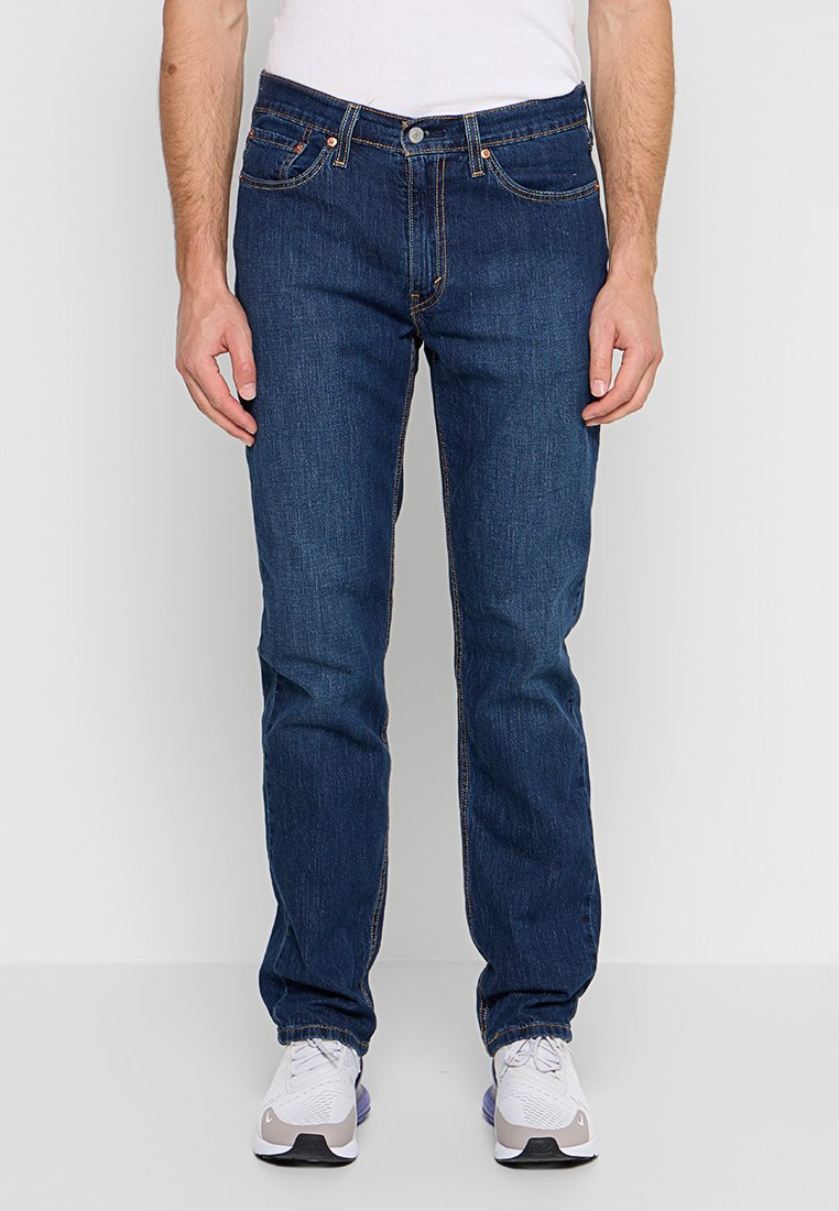 Dunkelblaue Jeans aus Denim mit geradem Bein. Verfügt über fünf Taschen, kontrastierende orangefarbene Nähte und einen Knopfverschluss.