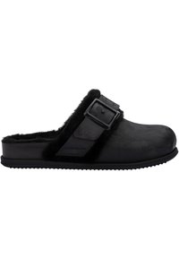 Black fur-lined clogs with a smooth exterior, featuring a side buckle and textured sole for traction. Rounded toe and raised edges.