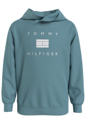 Teal hættetrøje lavet af blødt stof, med stort hvidt "Tommy Hilfiger" logo og enkel geometrisk design på forsiden.