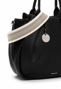 Black leather handbag with textured finish, featuring a braided white, gray, and beige strap and a silver charm tag.