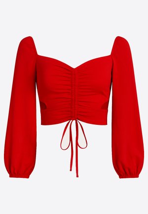 Top corto rojo con mangas largas abullonadas, detalle fruncido en el frente y cierre con lazo. Hecho de tela suave, con recortes en los costados.