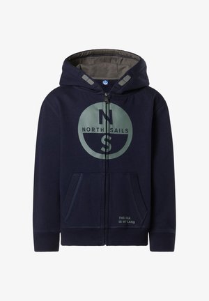Sweat à capuche zippé bleu marine en doux coton avec une doublure intérieure grise, arborant un logo circulaire et un texte au niveau de l'ourlet. Poches avant incluses.