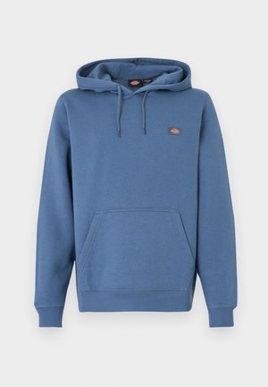 Hooded sweatshirt in a medium blue color, made from soft material with a front pocket, ribbed cuffs, and an embroidered logo on the chest.