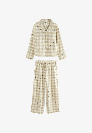 Chemise à manches longues beiges et blanches à carreaux, accompagnée d'un pantalon élastique à taille avec de petits motifs d'arbres verts.
