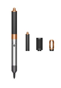 Strumento per lo styling dei capelli con corpo metallico argentato, manico nero testurizzato e dettagli in rame. Include un cilindro e accessori diffusori removibili.