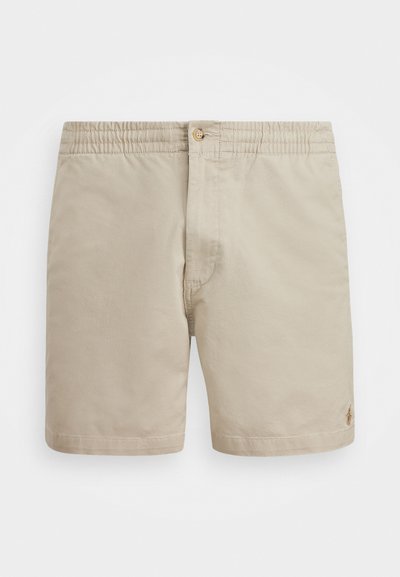 Beige shorts laget av lett stoff med elastisk midjebånd og en enkelt knappelukking. Har en liten logo på nedre høyre side.