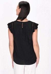Sort bluse med korte, flæseærmer og blonder detaljer. Ovale udsnit bagpå, glat tekstur og let buet kant.