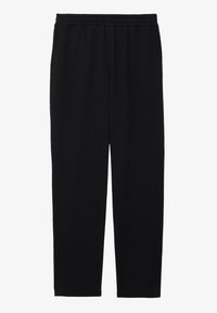 Pantalons de sport noirs avec taille élastique, coupe fuselée et texture de tissu douce, adaptés pour un usage décontracté ou pour faire de l'exercice.