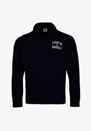 Marineblå sweatshirt med lynlås og ribbede manchetter og kant. Har hvid broderet tekst "FRANKLIN & MARSHALL" på venstre bryst. Blød tekstur.