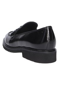 Schwarzer Lacklederschuh mit runder Zehenform, niedriger Plattformsohle und glatter Oberfläche. Mit einem dekorativen Riemen über dem Rist.
