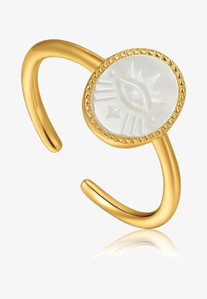Bague ajustable en doré avec un centre en nacre blanche en forme de rond, gravé d'un design d'œil et d'étoile. Fini lisse et poli.