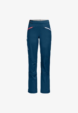 Marineblaue Outdoor-Hosen mit einer glatten Textur, roten und weißen Reißverschlussakzenten und einem taillierten Schnitt an den Knöcheln.