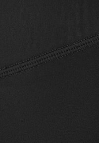 Black fabric with a smooth texture, featuring a seam running diagonally across the material, creating a layered appearance.