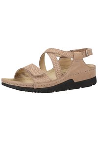 Beige leather sandal with crisscross straps, a textured finish, open toe, and a black rubber sole. Adjustable ankle strap for secure fit.