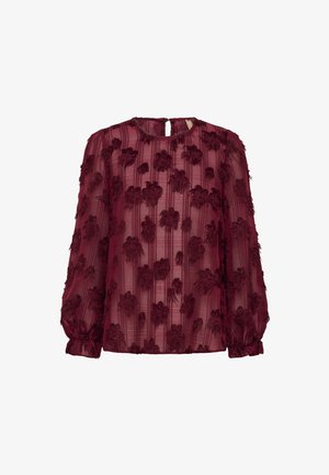 Burgundi áttetsző blúz virágmintával, hosszú puffos ujjakkal, kerek nyakkivágással és ráncolt mandzsettával. Jellemzője a függőleges csíkos textúra.