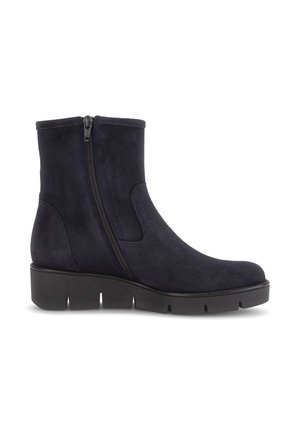 Black suede ankle boot with side zipper and thick grooved sole, designed for casual or outdoor wear.