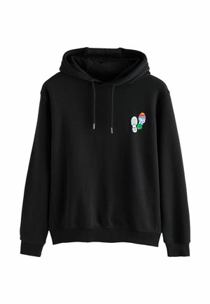 Black hoodie with front pouch pocket and small colorful footprint graphic on the left chest, featuring a rainbow-striped sole and "79" detail.
