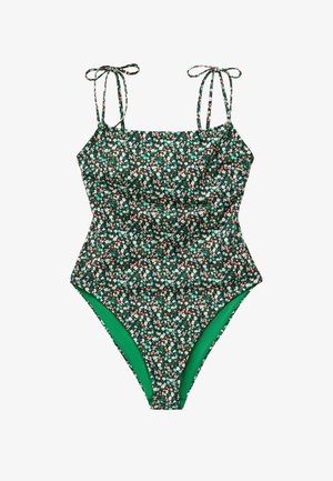 Maillot de bain une pièce vert à motifs floraux avec de petites fleurs blanches et roses, doté de bretelles nouées aux épaules et d'une coupe haute au niveau des jambes.