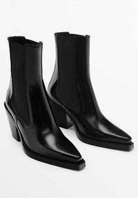 Black leather ankle boots with a pointed toe and block heel. Features elastic side panels for easy wear and a smooth, glossy texture.