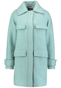 Cappotto di lana verde menta chiaro con colletto, due tasche frontali e maniche arrotolate. Tessuto testurizzato e design a taglio dritto.