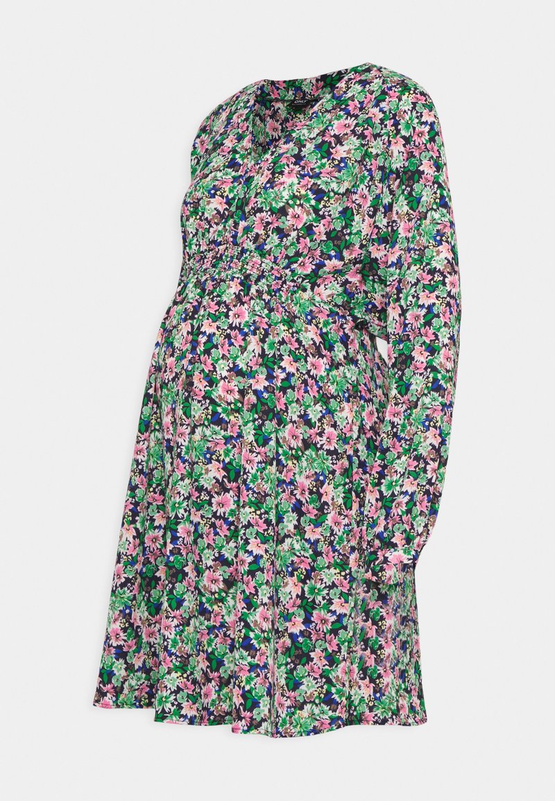 Vestido de maternidade floral com mangas longas, cintura franzida, fundo preto, apresentando flores em rosa, verde e roxo num padrão vibrante.