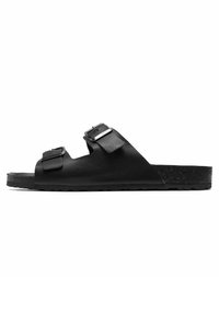 Svart läderslide sandal med två justerbara remmar, platt sula och strukturerad fotbädd. Enkel design med en minimalistisk estetik.