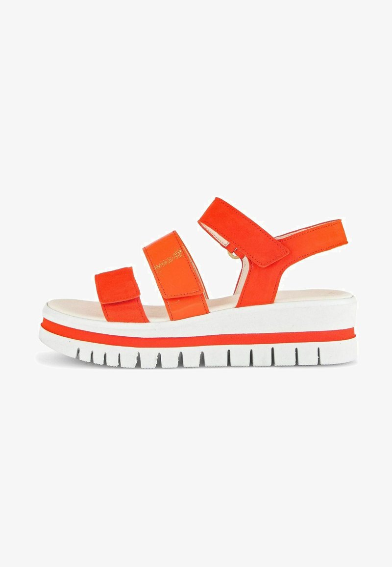 Orange suede sandal with three adjustable straps, white platform sole, and textured tread. Features a small gold accent on the strap.