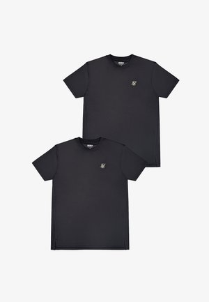 Deux t-shirts noirs à manches courtes avec col rond, ornés de petits logos monogrammes brodés en blanc sur le côté gauche de la poitrine, présentés superposés sur un fond blanc.