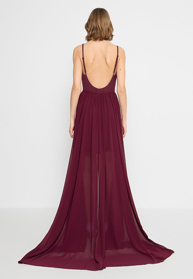 Burgunderrote Abendkleid mit tailliertem Oberteil, Spaghettiträgern und offenem Rücken, das einen fließenden, durchsichtigen Rock hat, der bis zum Boden reicht.