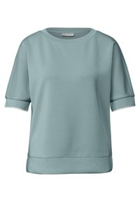 Sweat-shirt à manches courtes bleu clair en matériau doux, avec un col rond et des bordures blanches aux manches et à la taille. Texture lisse.