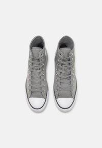 Gray high-top sneakers with a mesh upper, white rubber toe cap, and gray laces. Features black accents along the sole.