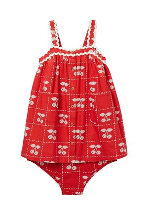 Robe rouge pour tout-petit avec motif cerises blanches, boutons sur le devant, bretelles festonnées et bas assorti attaché en dessous.