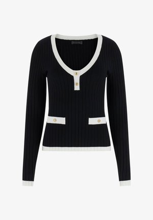 Zwarte geribbelde trui met lange mouwen, V-hals, witte bies en gouden knopen. Heeft twee voorzakken met witte accenten.