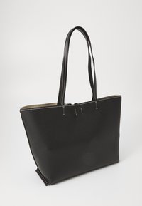 Black tote bag made of textured faux leather with two long handles and contrasting white stitching along the edges.