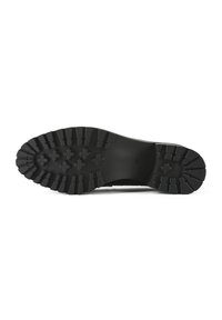 Semelle d'une chaussure noire avec des crampons épais et profonds présentant des motifs rectangulaires et en forme de croix pour une meilleure traction.