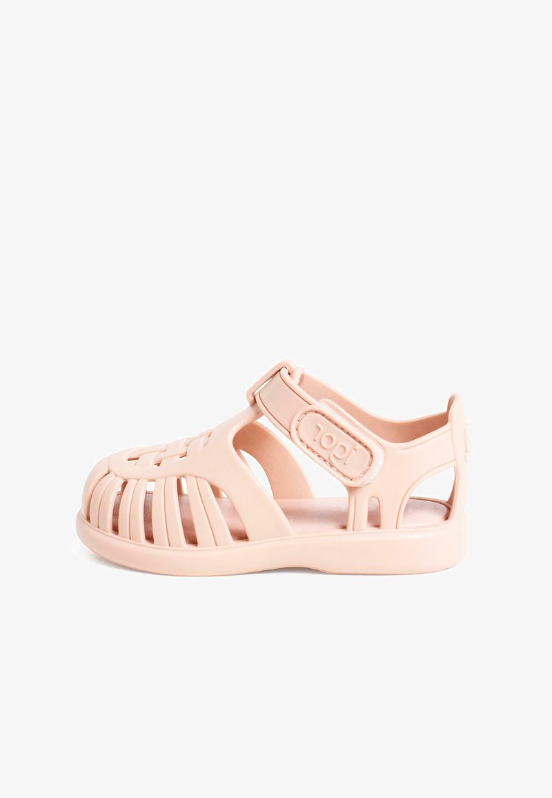 Pink plastic sandal featuring an open design with cutouts, an adjustable strap, and a cushioned sole. Reinforced heel and toe areas.