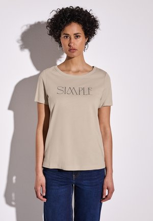 Beige tričko s krátkým rukávem a kulatým výstřihem, zdobené potiskem "SIMPLE" v tmavě šedé barvě na přední straně. Hladká textura látky.