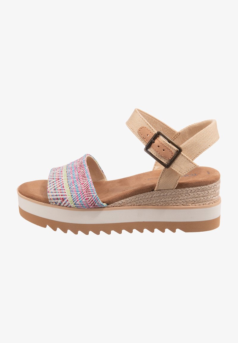 Multicolored fabric wedge sandal with a patterned upper, beige ankle strap, and white rubber sole featuring a textured, ridged design.