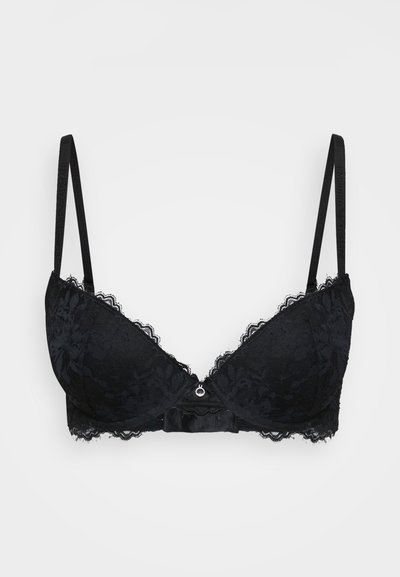 Must mustraks mustr õrnade padsikastega, sakilise pitsiga äärtega ja keskel dekoratiivse kaarega. Reguleeritavad rihmad ja sile kangastekstu.