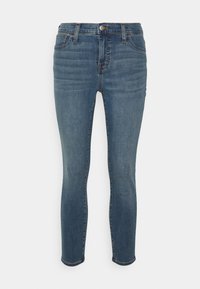 Mörkblå denimjeans med slim fit, midja med medelhög höjd, femficksdesign och subtila blekningar längs benen, avslutade med fållade benslut.