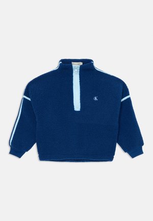 Navy blue fleece pullover with a quarter-zip front, light blue accents on sleeves, ribbed cuffs, and an embroidered logo. Soft, textured fabric.