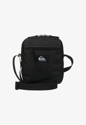 Black crossbody bag made of durable fabric, featuring a front zip pocket, adjustable strap, and a logo patch on the front.