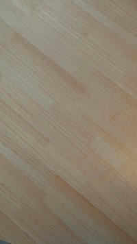 Šviesios spalvos medinės grindys su lygia tekstūra, turinčios natūralų medienos raštą ir subtilius atspalvių skirtumus.