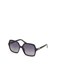Black, oversized sunglasses with a glossy frame. Gradient lenses from dark to light gray. Features a small logo accent on the temple.