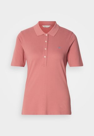 Short-sleeve dusty pink polo shirt with a collar, four buttons, and small embroidered logo on the left chest.