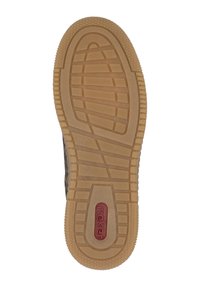 Semelle en caoutchouc avec un motif de semelle et un logo rouge central, présentant une surface beige lisse et des détails de traction rectangulaires.