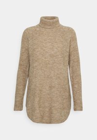 Pull à col roulé beige en maille texturée avec manches longues et ourlet légèrement courbé, offrant une silhouette décontractée.